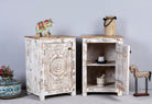 Side angle image with open door of a set of two hand carved bedside tables with mandala and floral motifs; reclaimed wood in white washed furniture style, 50 × 40 × 72 cm.