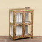Side angle image of a Nikhil hand painted reclaimed wood display cabinet with colourful floral design and four open display sections 120cm