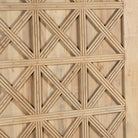 Close-up of a wooden panel with a geometric lattice pattern