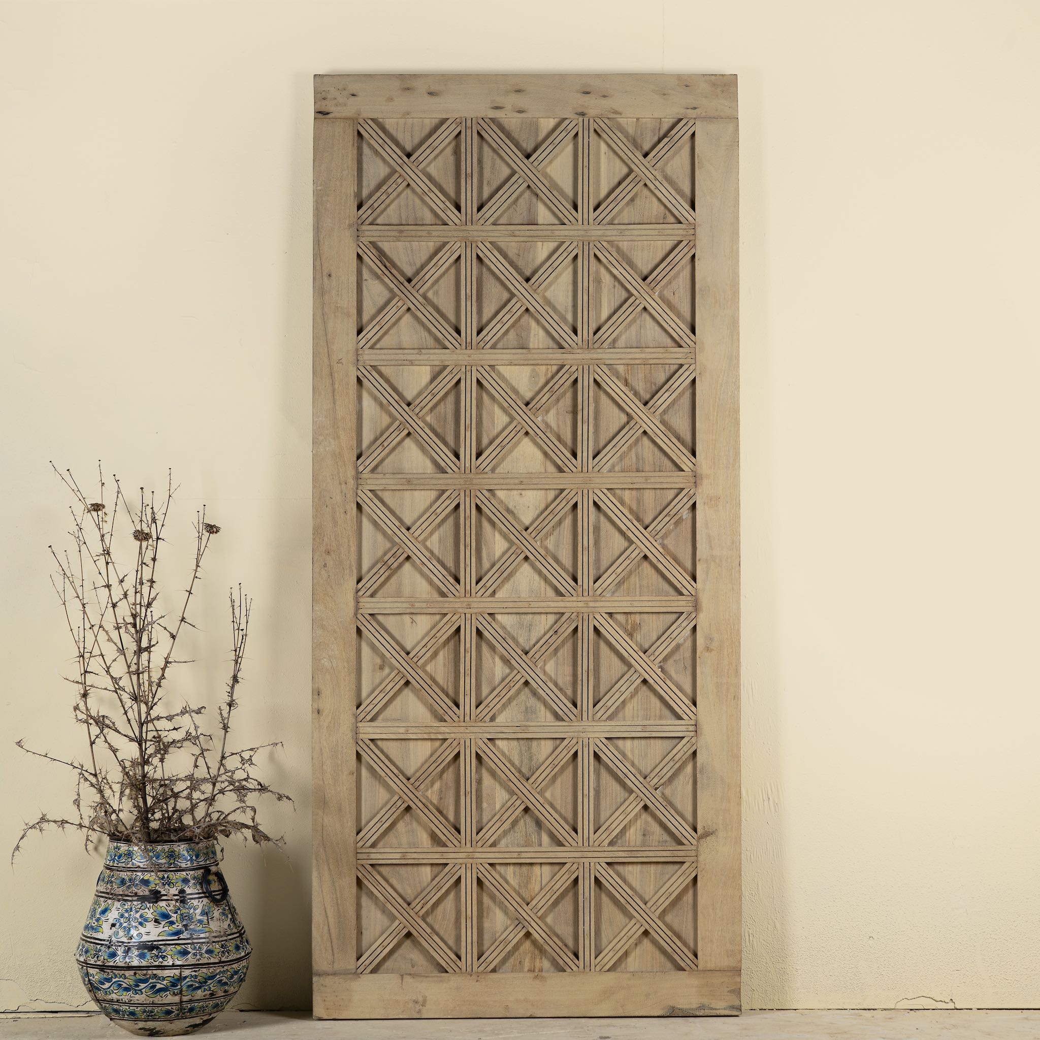 Vintage wall panel Nila, handcrafted reclaimed wood Indian door with geometric carvings, 100 × 5 × 220 cm.