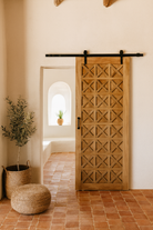 Life style scene with a vintage wall panel Nila, handcrafted reclaimed wood Indian door with geometric carvings, 100 × 5 × 220 cm.