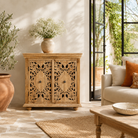 Lifestyle image of a Nilay hand carved mango wood cabinet with floral carved doors 90x90cm