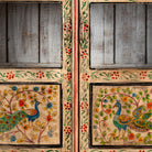 Close up image of a Nirav hand painted reclaimed teak display cabinet with floral, peacock, elephant and leopard motifs 190cm