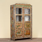 Side angle image of a Nirav hand painted reclaimed teak display cabinet with floral, peacock, elephant and leopard motifs 190cm