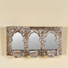 Triple arched hand-carved wooden mirror with distressed brown and white finish and three candle holders – ideal for Indian and vintage home accessories.