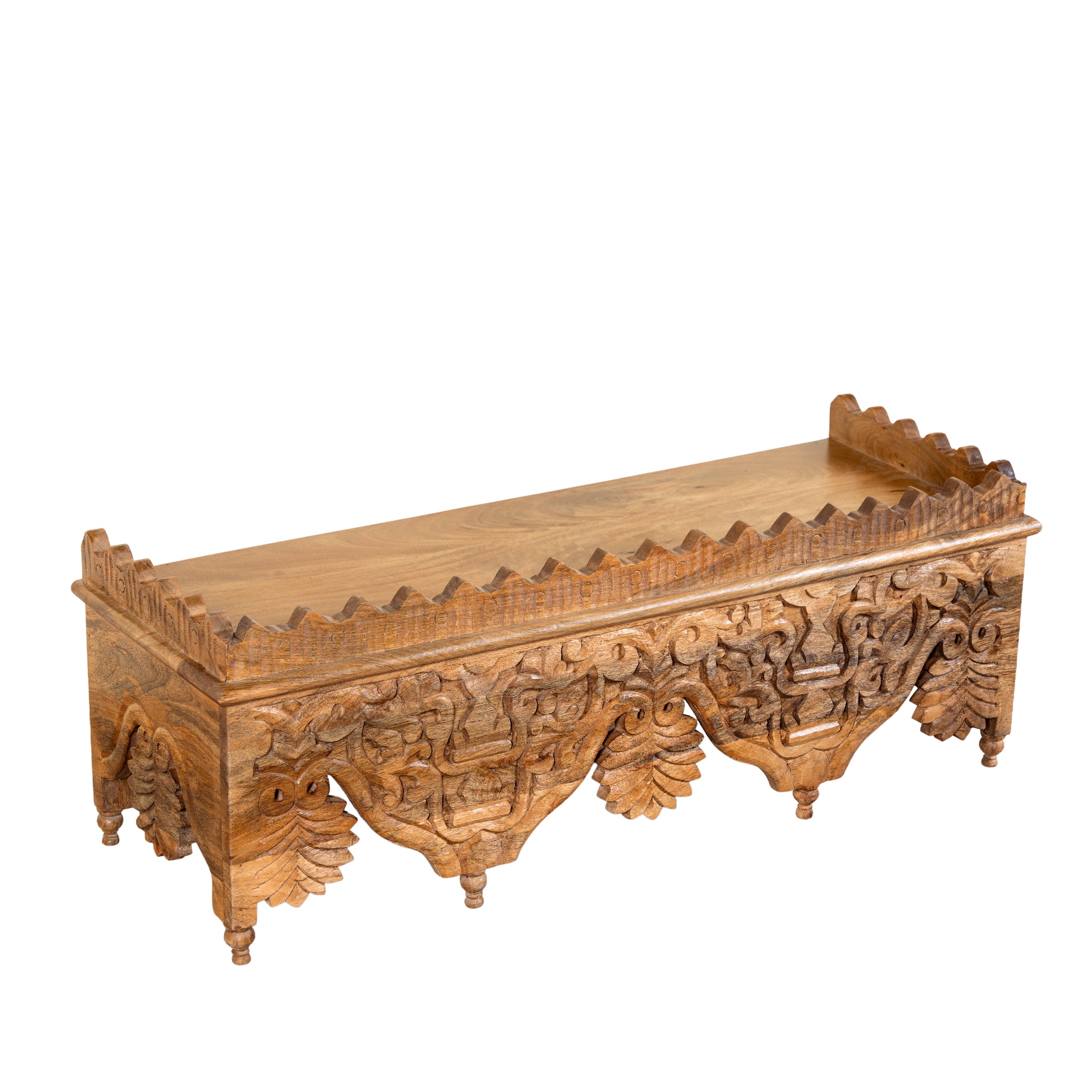 Side angle image of a Nirvay hand carved mango wood wall shelf with floral carvings and decorative hanging leaf ornaments 90cm
