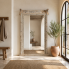 Lifestyle image of a Nirved reclaimed teak wood mirror crafted from an antique entrance door frame with bleached finish, 180x110cm