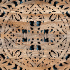 Close up image of the carvings of a  hand-carved Indian 4-poster bed in solid mango wood with canopy design, rustic bedroom furniture, 180 × 200 cm.