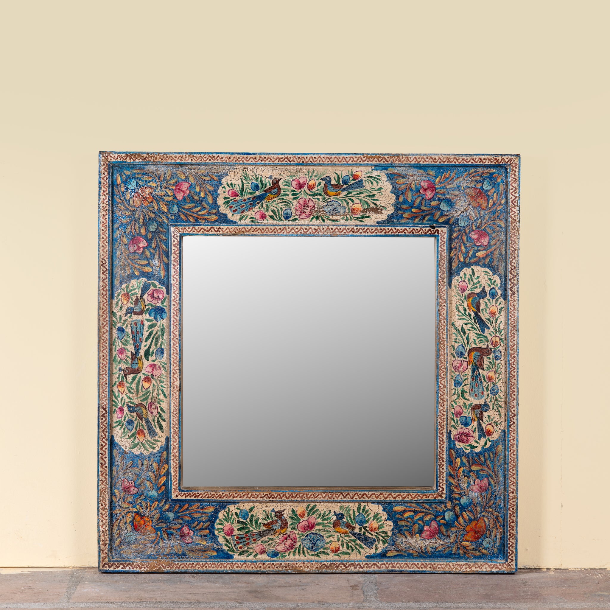 Nithya hand-painted reclaimed wood wall mirror featuring colourful peacocks, birds and floral Indian artwork, 90x90x5cm.