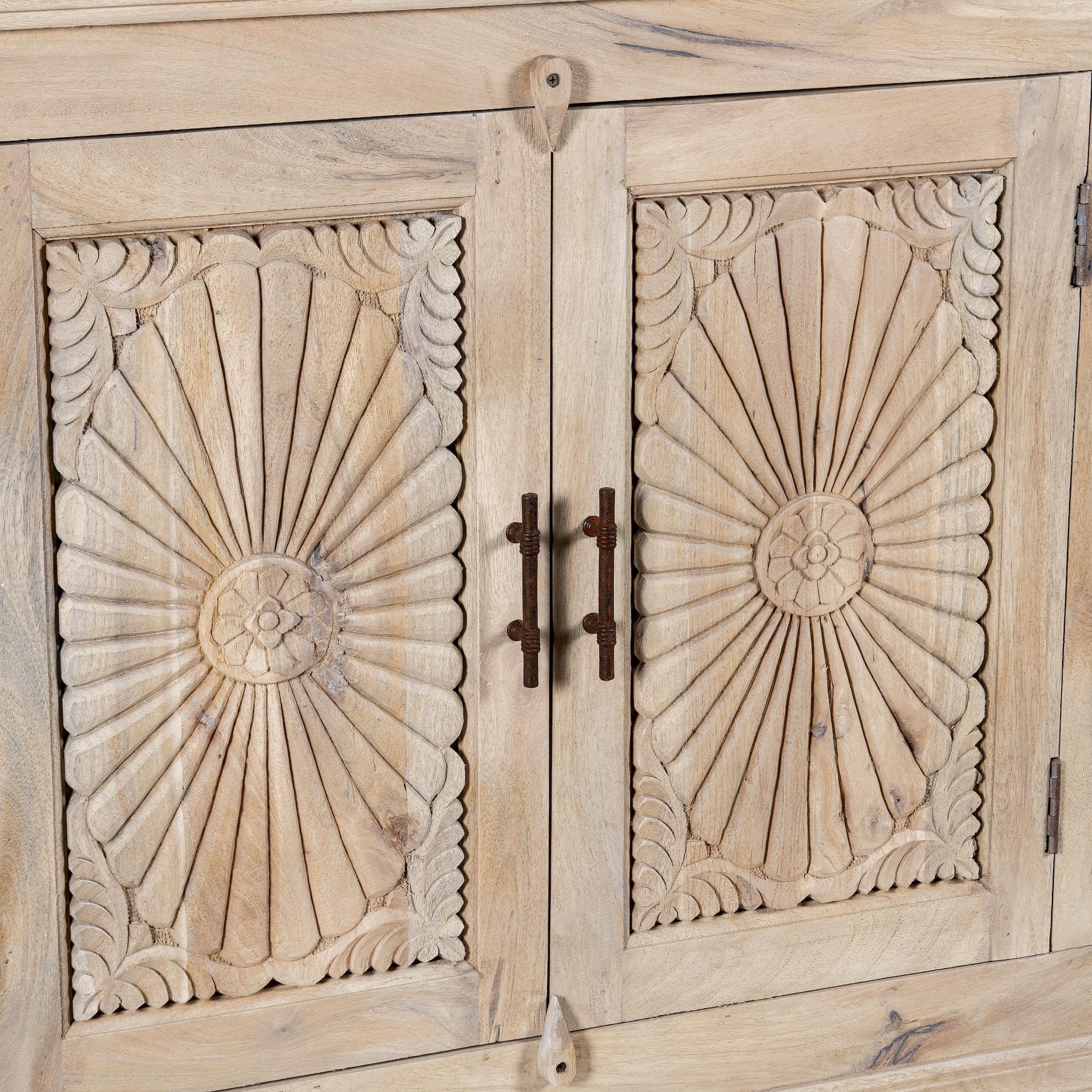 Close up image of a hand-carved mango wood sideboard with sandblasted finish – a rustic mango wood furniture piece ideal for Ibiza style interiors.