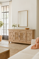 Lifestyle scene with a hand-carved mango wood sideboard with sandblasted finish – a rustic mango wood furniture piece ideal for Ibiza style interiors.