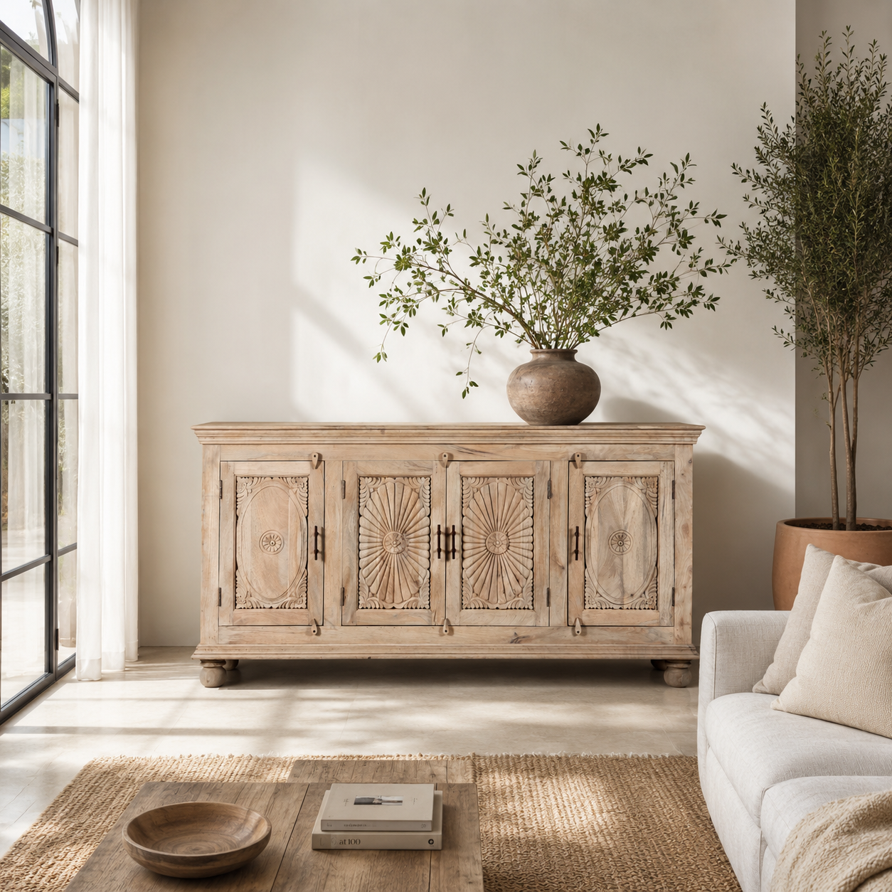 Lifestyle scene with a hand-carved mango wood sideboard with sandblasted finish – a rustic mango wood furniture piece ideal for Ibiza style interiors.