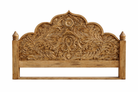Close up image of a mango wood bed frame with hand carved headboard in vintage style.