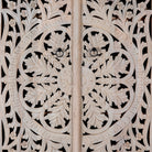 Close up image of a hand-carved mango wood wardrobe, a statement piece of bedroom furniture ideal for a bohemian interior.