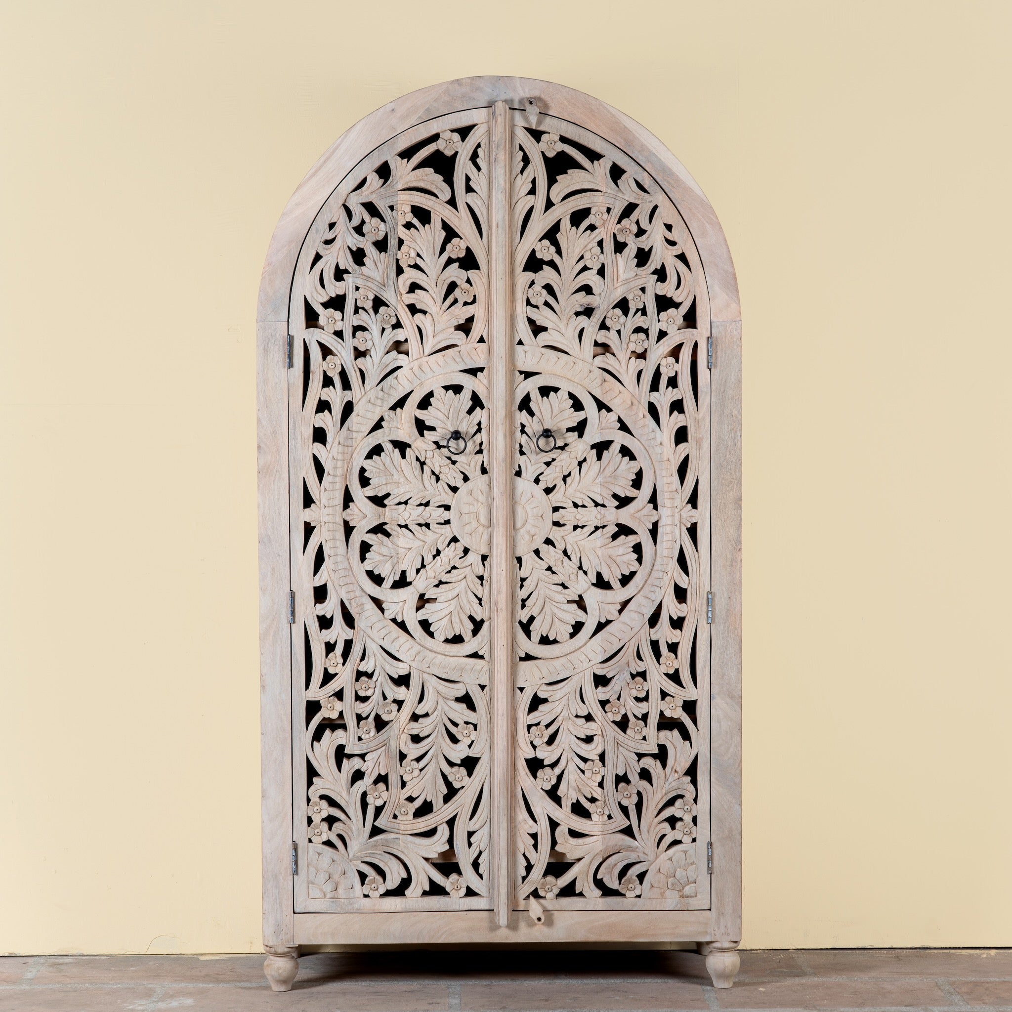 Image of a hand-carved mango wood wardrobe, a statement piece of bedroom furniture ideal for a bohemian interior.