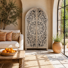 Lifestyle image of a hand-carved mango wood wardrobe, a statement piece of bedroom furniture ideal for a bohemian interior.