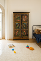 Lifestyle image of a hand-painted cabinet made from recycled wood with floral motifs – sustainable furniture and unique furniture for bold, artistic interiors.