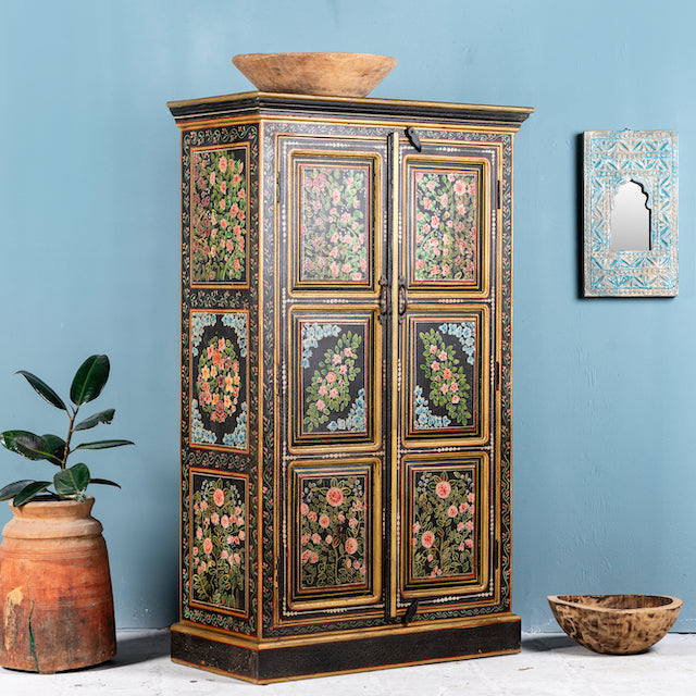 Side angle image of a hand-painted cabinet made from recycled wood with floral motifs – sustainable furniture and unique furniture for bold, artistic interiors.