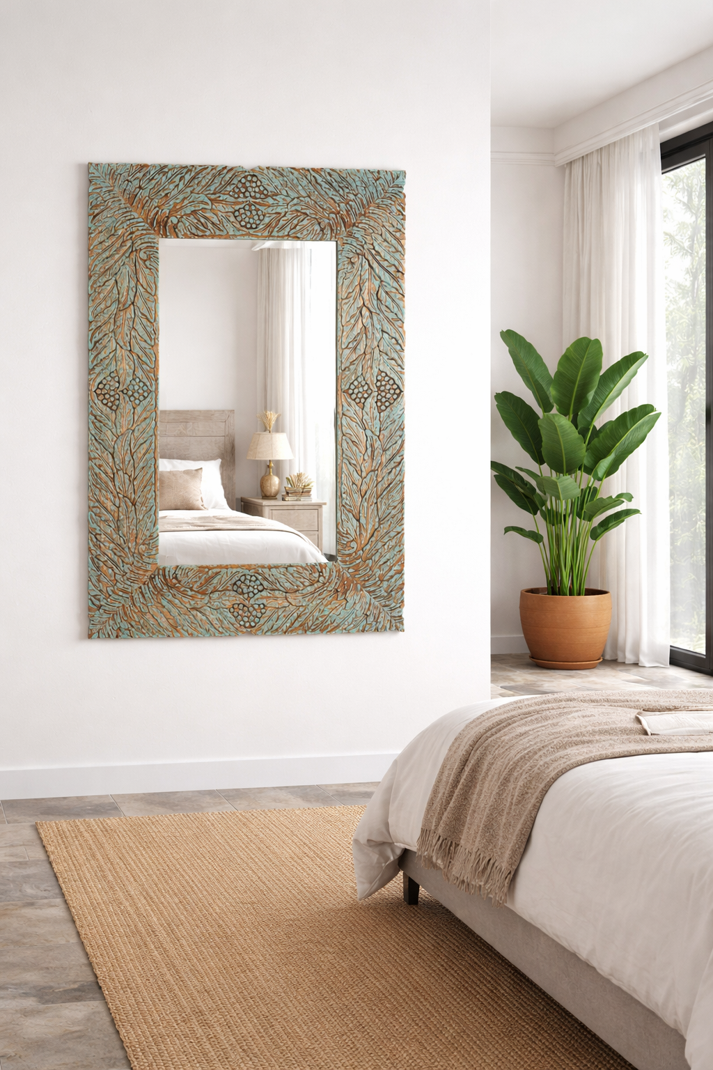 Lifestyle imagination of a carved mango wood mirror Anumati with floral hand-carving and distressed finish. A unique Indian furniture piece perfect for vintage home decor and bohemian interiors.