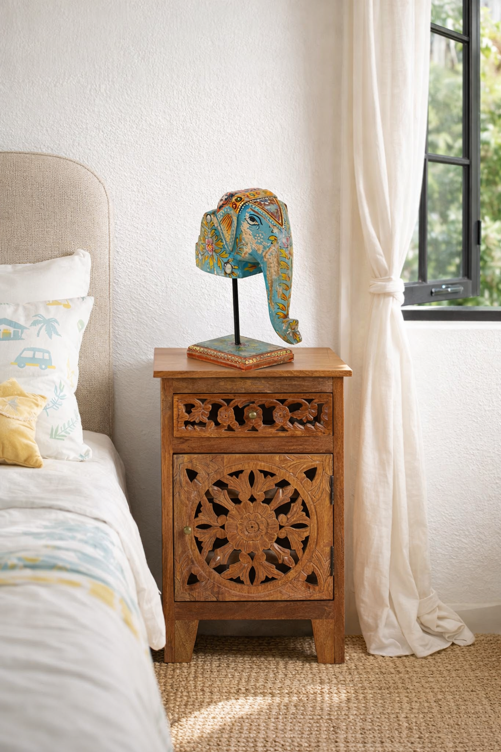 Lifestyle imagination of a hand-painted decorative wooden elephant head on iron stand with floral Indian folk art – ideal for Indian and vintage home accessories.