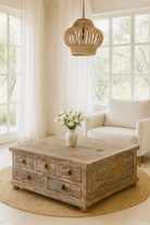 Lifestyle imagination of a handcrafted mango wood coffee table Box Table Panipat with drawers and box storage, vintage coffee table design, 90 × 90 × 45 cm.