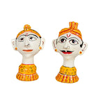 White background image of a set of 2 hand-painted Rajasthani papier maché heads featuring a man and woman in traditional attire, ideal for vintage home decoration and Indian home decor.