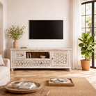 Lifestyle image of a hand-carved mango wood TV unit Pari in Mediterranean style, versatile living room furniture with drawers and compartments, 170 × 60 × 37 cm.