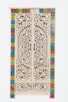 White background image of a Hand-carved mango wood cabinet with white-wash finish and ceramic detailing – artisanal furniture and carved wooden furniture with Mediterranean flair.