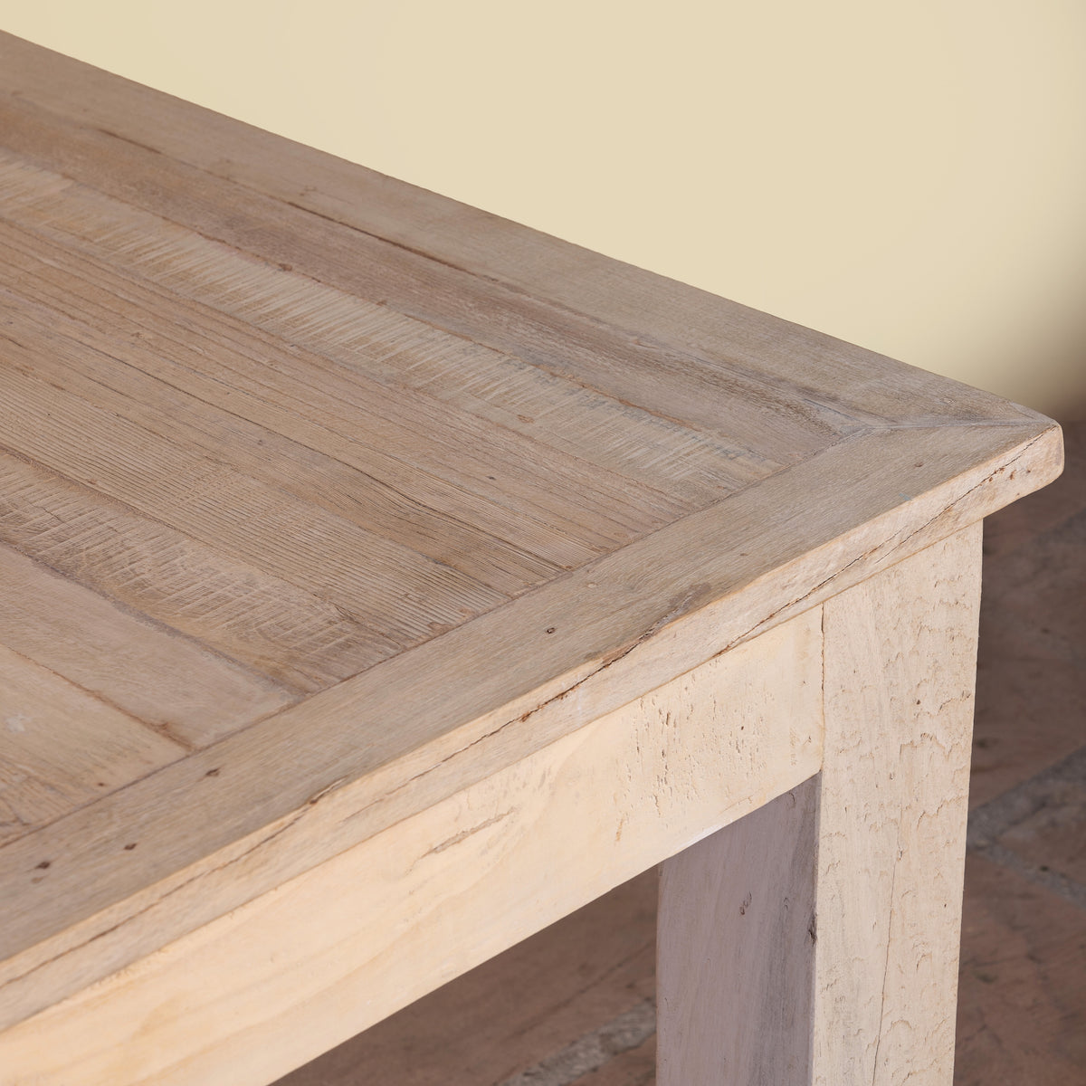 Close up image of a Parthiv bleached reclaimed wood dining table with rectangular top and straight wooden legs, 180x90x76cm