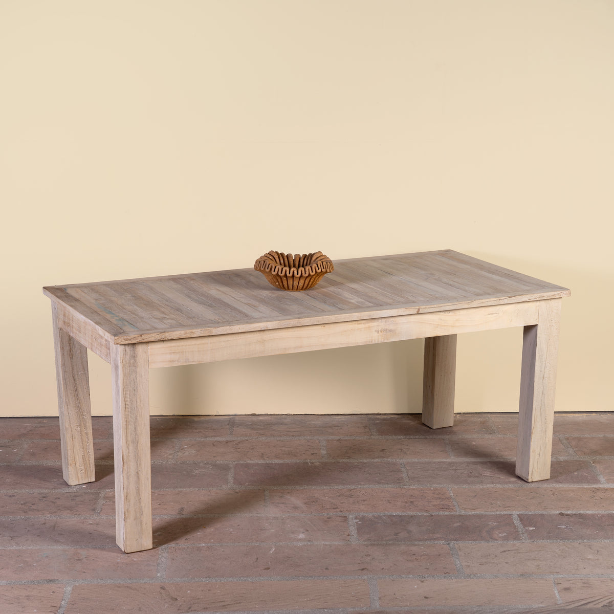 Side angle image of a Parthiv bleached reclaimed wood dining table with rectangular top and straight wooden legs, 180x90x76cm