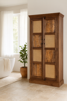 Lifestyle imagination of a tall mango wood furniture cabinet with hand-carved details and woven rattan doors, artisan rattan furniture, 90 × 40 × 180 cm.