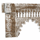 Close up image of a hand‑carved mango wood mirror Persia with floral wooden frame. A bold piece of carved wooden mirror and unique wall decoration for vintage and bohemian interiors.
