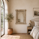 Lifestyle image of a hand‑carved mango wood mirror Persia with floral wooden frame. A bold piece of carved wooden mirror and unique wall decoration for vintage and bohemian interiors.