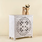 Side angle image of a white carved wood cabinet made from solid mango wood with hand-carved Indian motifs, 90 × 90 × 40 cm.