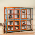 Open door image of a hand-painted reclaimed wood showcase cabinet with Ibiza-style motifs, glass-panelled doors, unique wooden furniture for living room, 213 × 40 × 170 cm.