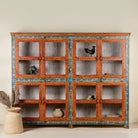 Hand-painted reclaimed wood showcase cabinet with Ibiza-style motifs, glass-panelled doors, unique wooden furniture for living room, 213 × 40 × 170 cm.