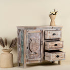 Open drawer image of a handcrafted cupboard made from reclaimed wood with a carved turtle motif and pastel finish; vintage furniture and sustainable furniture, 110 × 96 × 40 cm.