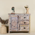 Handcrafted reclaimed wood cupboard with a turtle design, featuring one door and three drawers, placed against a neutral background with decorative items on top.