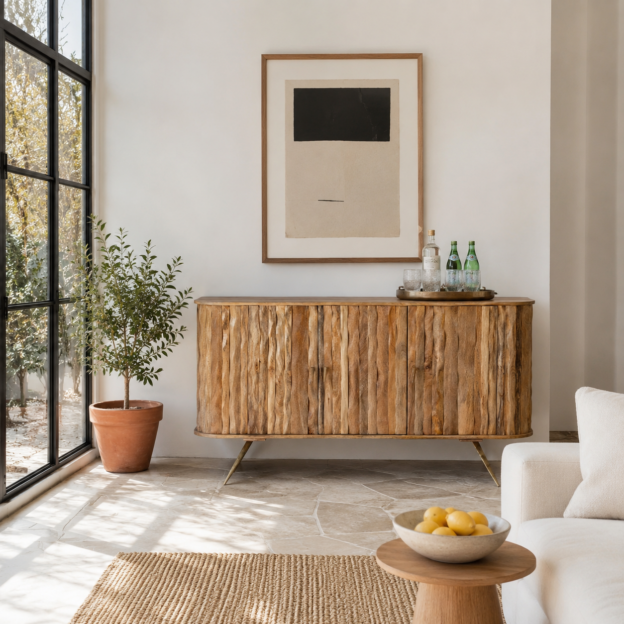 Lifestyle image of a handmade mango wood sideboard with live-edge design, brass-coated base, and handles—an artisanal furniture piece combining natural and modern elements.