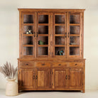 A large, solid teak wood showcase cabinet with glass panelled doors on the upper section and solid wood doors on the lower section, set against a neutral background.