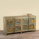 Side angle mage of a Pavan hand-painted reclaimed wood sideboard with original Indian teak doors and colourful tiger, camel, elephant, horse and lion motifs 193cm