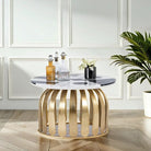 Lifestyle imagination of a round industrial style coffee table with hand-forged metal base and checkered marble top; also functions as a metal bar table, 82 cm diameter, 45 cm height.