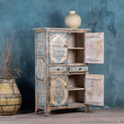 Open door image of a hand-painted wooden cabinet made from reclaimed wood with blue floral motifs – sustainable furniture with artistic charm and vintage appeal.