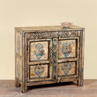 Side angle image of a Prithvi reclaimed wood cabinet with original Indian doors and hand-painted blue and white floral design.