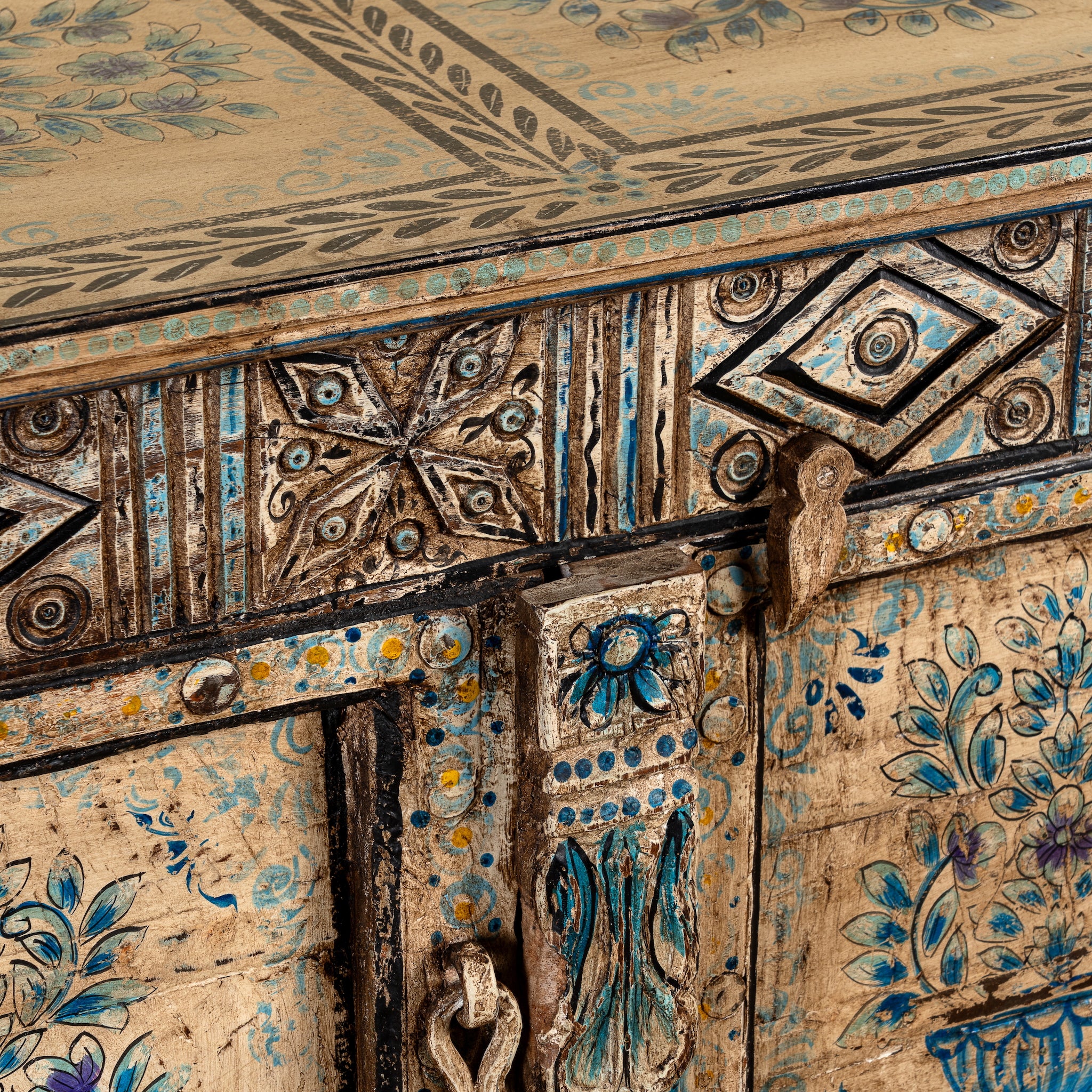 Close up image of a Prithvi reclaimed wood cabinet with original Indian doors and hand-painted blue and white floral design.