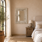 Lifestyle image of a vintage mango wood mirror with hand-carved frame; rectangular wall mirror, 76 × 102 cm.