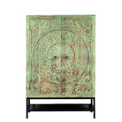 White background image of a carved mango wood cabinet with floral hand-carving, distressed green finish, iron stand, 100 × 40 × 150 cm.