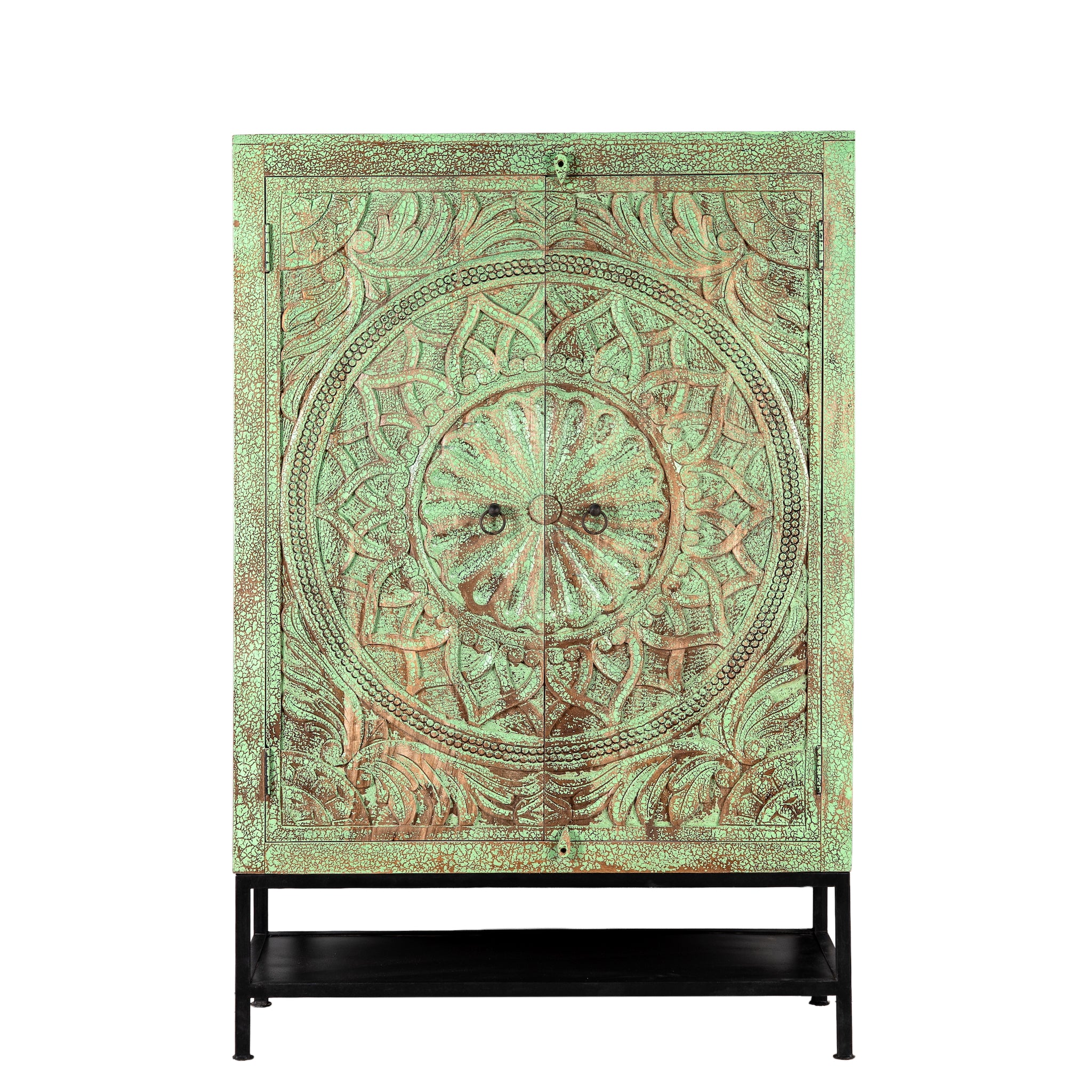 White background image of a carved mango wood cabinet with floral hand-carving, distressed green finish, iron stand, 100 × 40 × 150 cm.