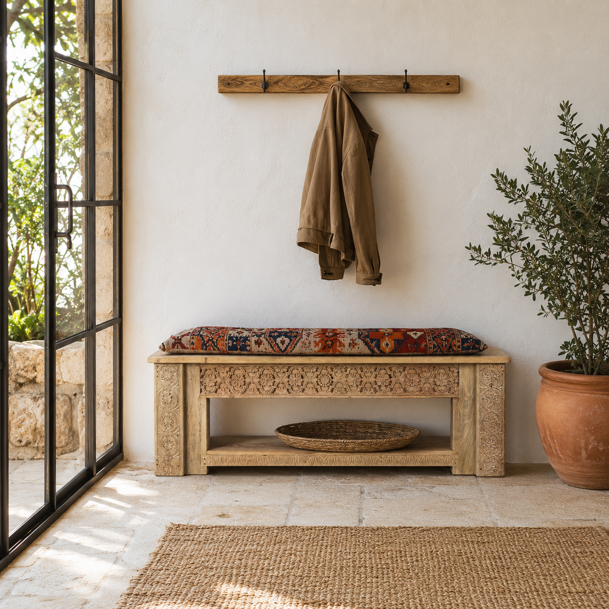 Lifestyle image of a Purna reclaimed teak wood bench with hand carved Indian house elements and lower shelf 160cm