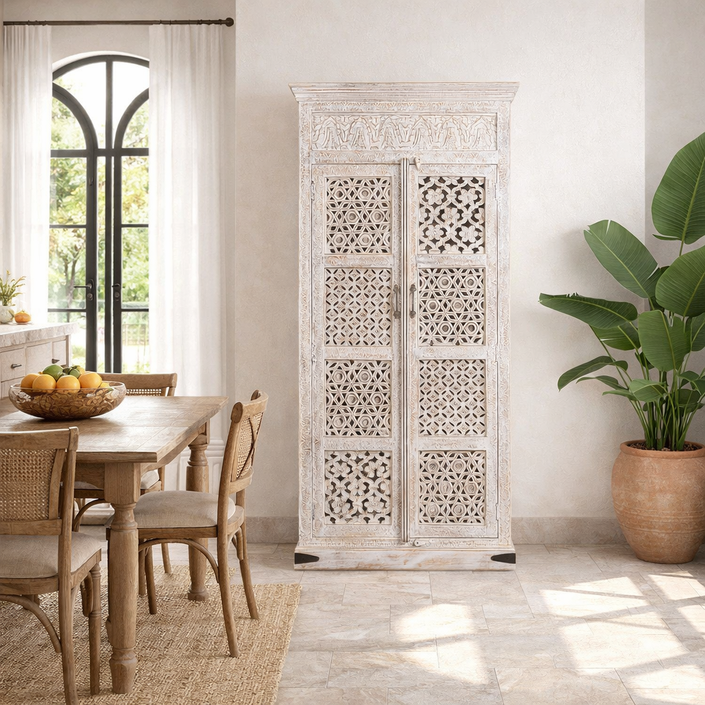 Lifestyle image of a hand-carved mango wood wardrobe with whitewashed finish, bedroom furniture wooden wardrobe with floral and geometric lattice doors, 90 × 190 × 40 cm.